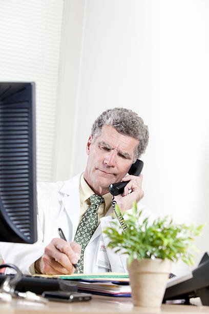 istock White mature Doctor on Telephone 183278000