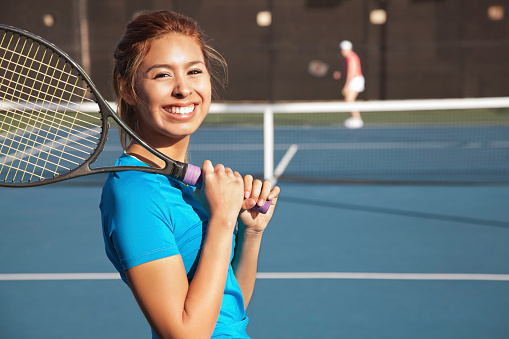 Pretty Teenage Tennis Player Holding A Racket and Playing a Match. Copy Space Available.See more from this series: