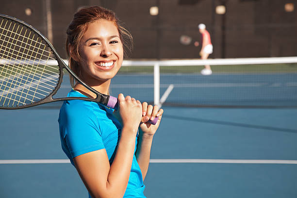 Pretty Teenage Tennis Player Playing a Match Pretty Teenage Tennis Player Holding A Racket and Playing a Match. Copy Space Available.See more from this series: individual event stock pictures, royalty-free photos & images