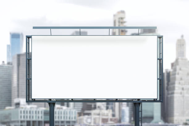 istock Blank white billboard on city buildings background at daytime, front view. Mockup, advertising concept 1832782189
