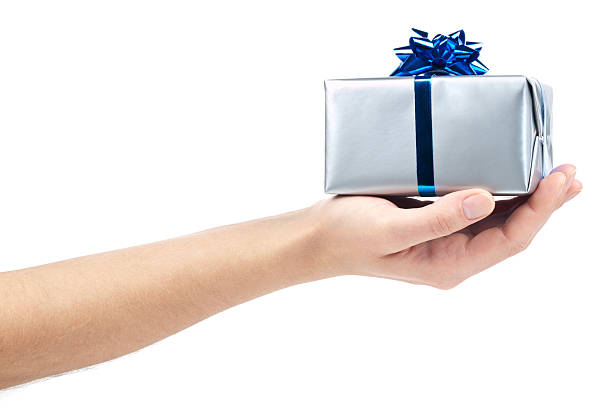 Gift box Silver gift box with blue ribbon on hand. This file contains hand holding gift stock pictures, royalty-free photos & images