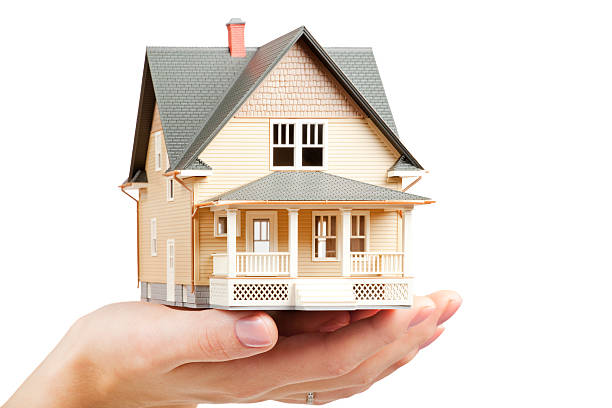 istock Classic miniture model home held in female hand 183279080