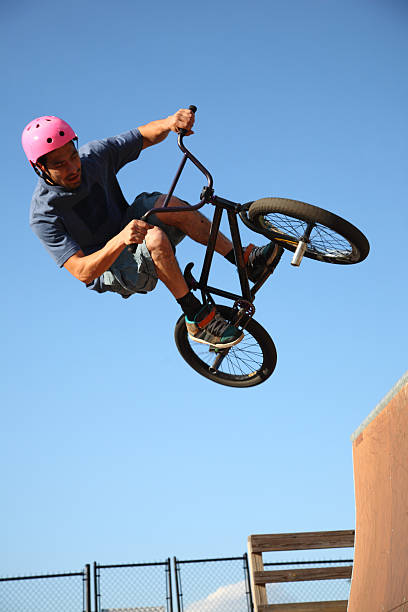 Airborne BMX Rider Above Outdoor Ramp stock photo