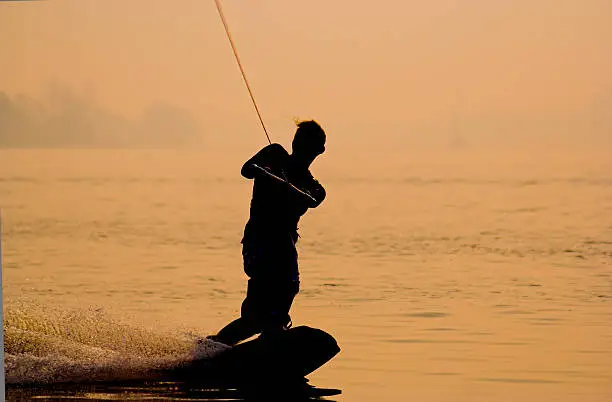 "Wakeboarder performing a jump, sun is creating a nice gold blazeMore pictures of action sports :"