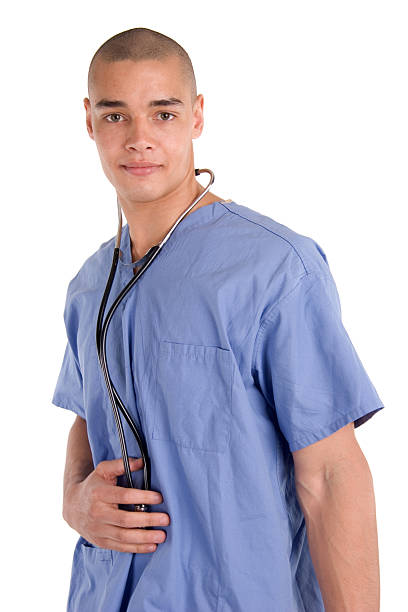 Male Nurse with Stethoscope 2 Male nurse standing with scrubs and stethoscope smiling male nurse male healthcare and medicine technician stock pictures, royalty-free photos & images