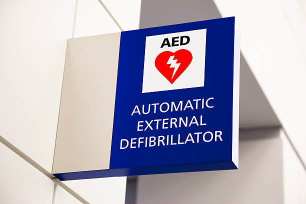 Blue automated external defibrillator sign mounted on a wall stock photo