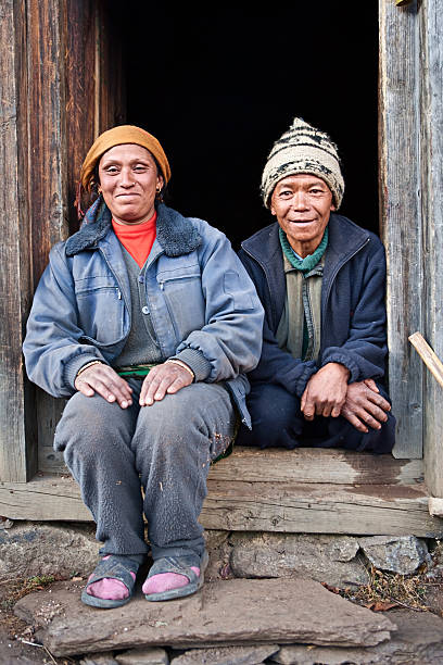 istock Nepali couple in front of their house 183280158