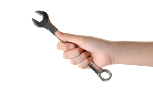 Chinese female hand holding a wrench isolated on white with clipping path.