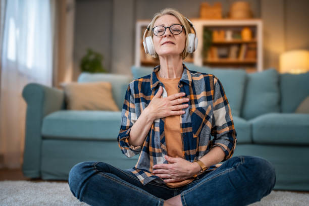 istock Elderly Caucasian woman using headphones for online guided meditation 1832804664