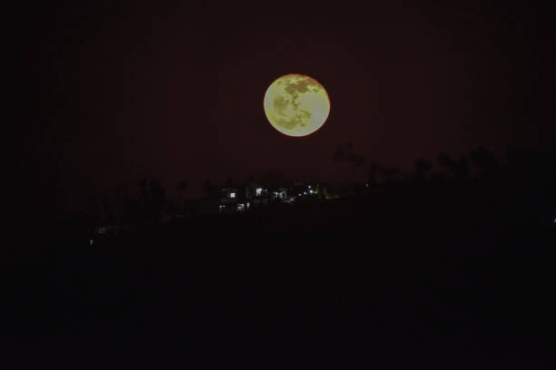 istock Full moon rise and village lights. 1832808434