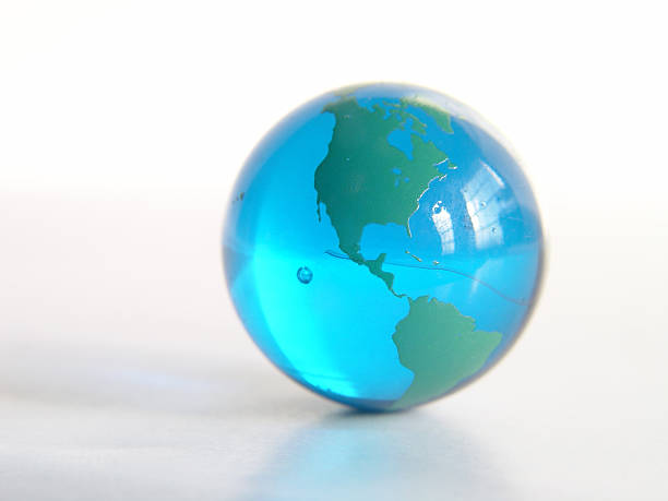 Marble World Blue marble globe with light reflecting off of and around it. marble globe stock pictures, royalty-free photos & images