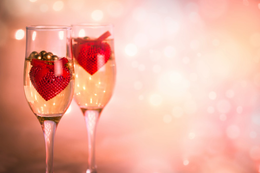 Wine and red hearts against a defocused background. Valentine's Day.