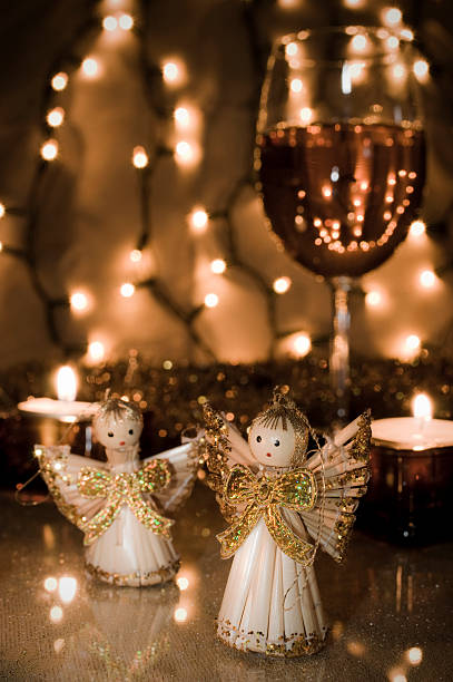 Two Angel Dolls in Front of the Christmas Decoration stock photo