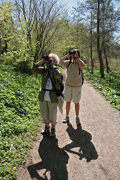 istock Two mature women are watching birds in spring 183282055