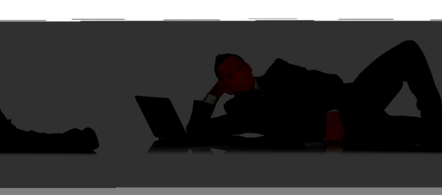 Businessman reclining beside laptophttp://www.twodozendesign.info/i/1.png