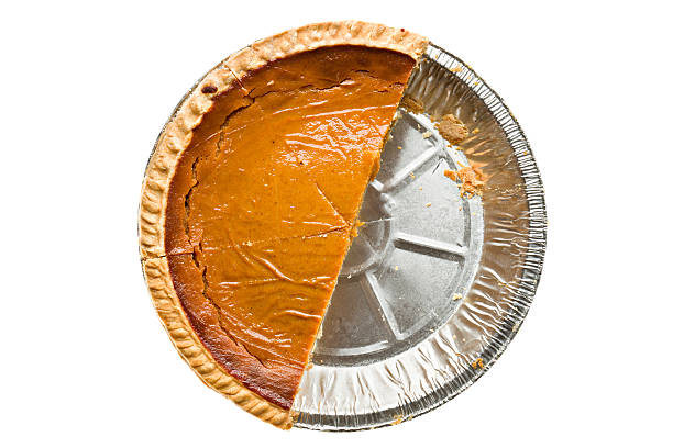 Overhead View of Half A Pumpkin Pie Overhead view of half of a pumpkin pie. half full stock pictures, royalty-free photos & images