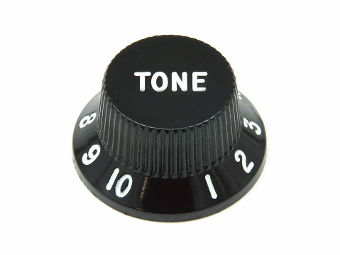 A tone control knob from a Fender bass guitar