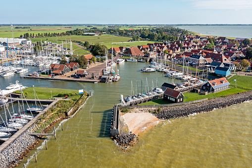 Aerial from the historical harbor and city Hindeloopen at the IJsselmeer in the Netherlands on a busy summer day
