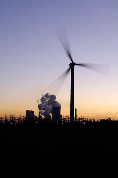 istock Wind turbine and power plant at dusk 183283218