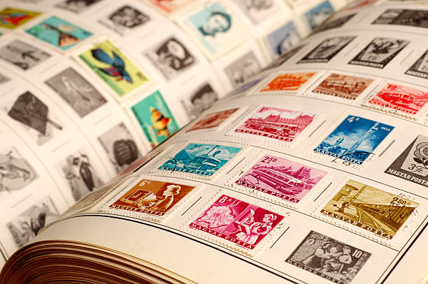 Collecting Vintage Stamps - #1 Closeup color photo of a vintage stamp album with colorful old stamps.  Selective focus on front stamps. stamp collecting stock pictures, royalty-free photos & images