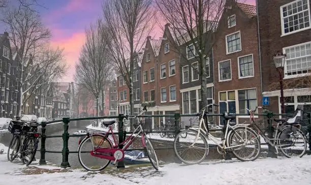 Photo of City scenic from snowy Amsterdam the Netherlands at sunset