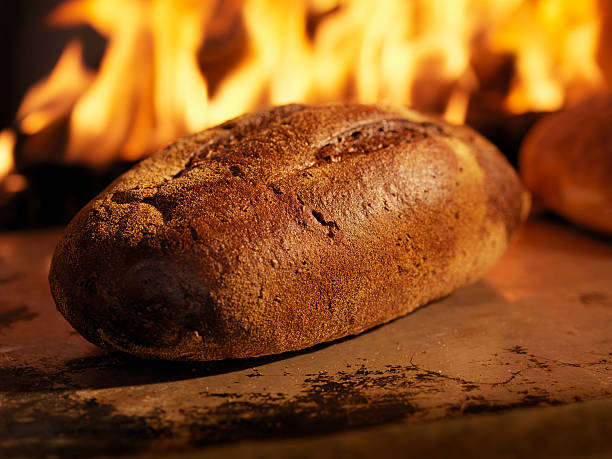 istock Pumpernickel Bread in a Wood Burning oven 183283861