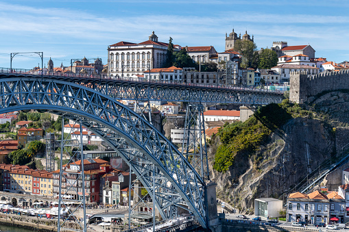 Porto, Portugal-October 2, 2022; Dom Luís I metal double-deck arch Bridge (Ponte de Dom Luís I) that spans River Douro between Porto and Vila Nova de Gaia with old city in background