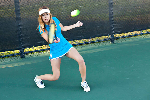 istock Female Tennis Player Hitting the Ball 183284340