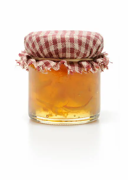 Photo of Homemade jar of marmalade isolated in white