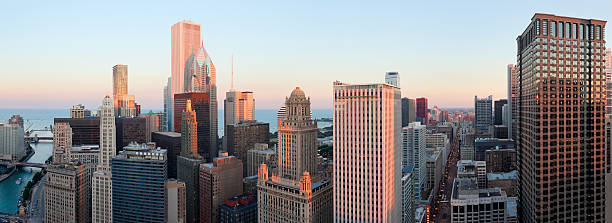 Aerial Panoramic View of Chicago at Sunset (XXXL) "Aerial panoramic view of high-rises in downtown Chicago at sunset.  Chicago River at left, State Street at right.XXXL file - can be easily cropped to suit.For more Chicago images, see:" aon center chicago photos stock pictures, royalty-free photos & images