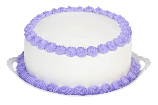 Homemade birthday or party cake frosted with white icing and decorated with Violet details. The top of the cake is plain white so you can personalize it.
