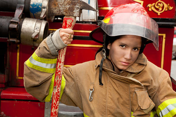 istock Young Female Firefighter Sitting Next To Firetruck 183284695