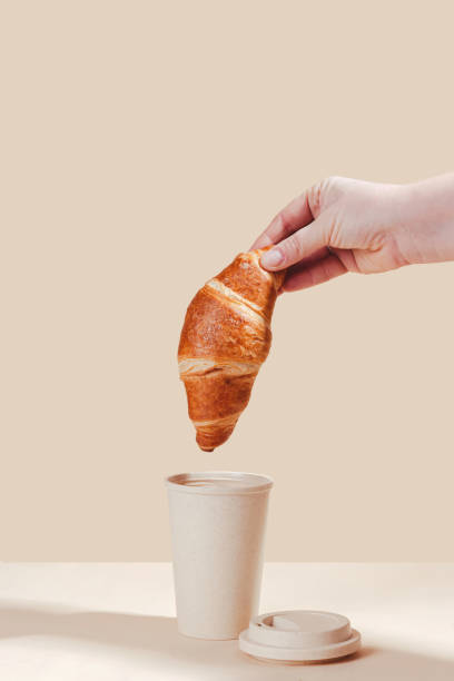 istock Fresh delicious croissants with an eco cup on a light background. 1832853676