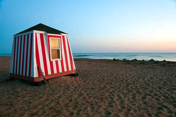 Beach Hut "A red and white striped beach hut on Cavendish Beach, Prince Edward Island." cavendish beach at prince edward island national park canada stock pictures, royalty-free photos & images