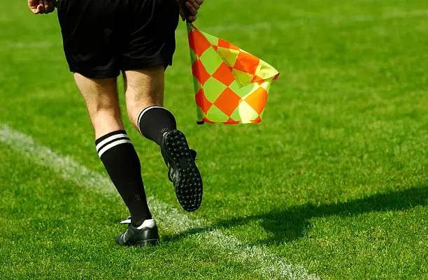 Running Soccer Referee with flag