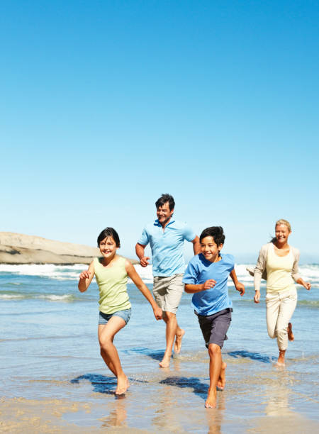 istock Family running along the beach 183286160