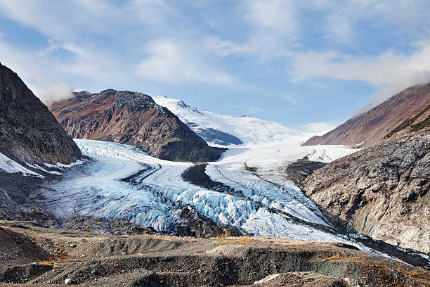istock Mountainous terrain with snow and blue cloudy sky 183286517