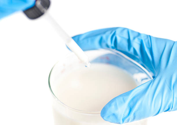 testing white liquid milk - Blue gloves pipette in the laboratory