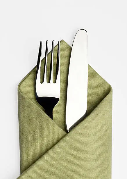 Photo of Knife and fork in a green napkin