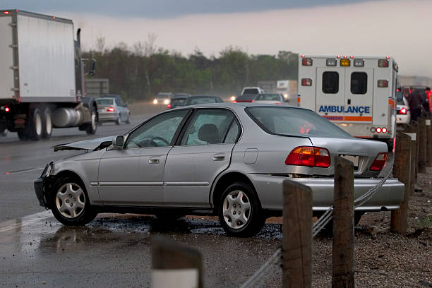Rainy Night Crash 2 Car accident on rainy night on freeway. Ambulance in background. Zoom in for detail. truck rain stock pictures, royalty-free photos & images