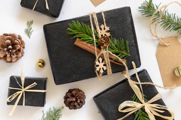 istock Black gift boxes, Christmas decor and green fir branches top view 1832872532