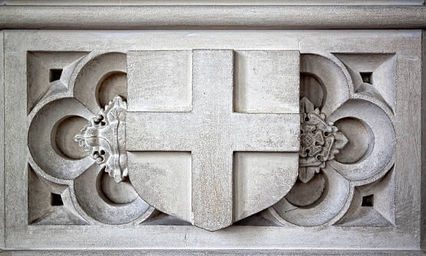 istock Stone shield and cross detail on a church font 183287319