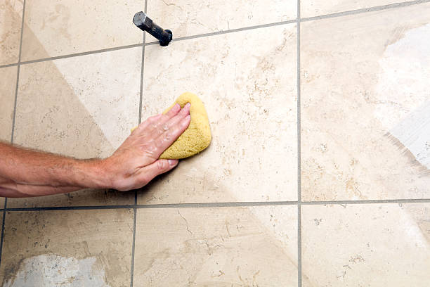 istock Tile Setter Wiping Grout from Shower Wall 183287578