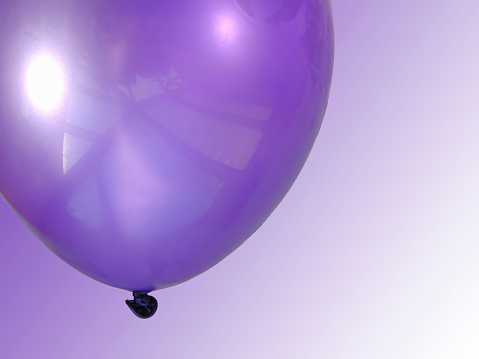 Purple balloon isolated on white background. Template for postcard, banner, poster, web design. Festive decoration for celebrations and birthday. High resolution photo.