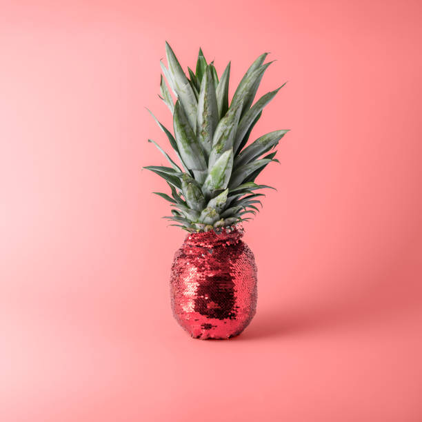 istock Creative fruit concept. Pineapple in red glittery evening dress on pink pastel background. 1832881607