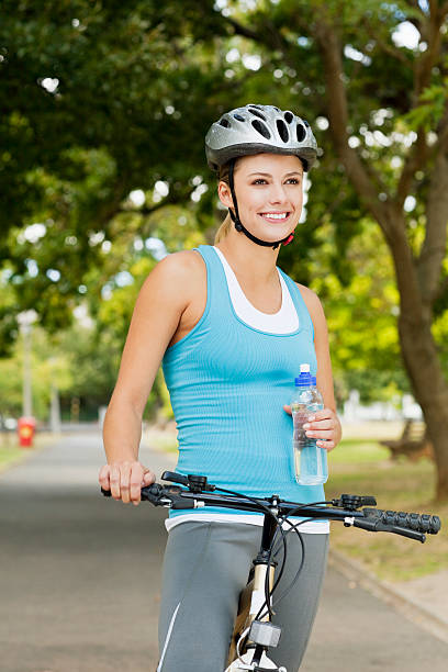 istock Young Woman with a Bicycle in the Park 183288199