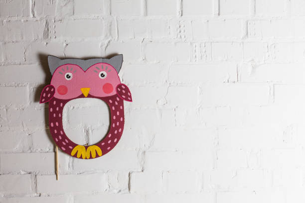 istock Bright cardboard masks on a white brick wall. 1832891761