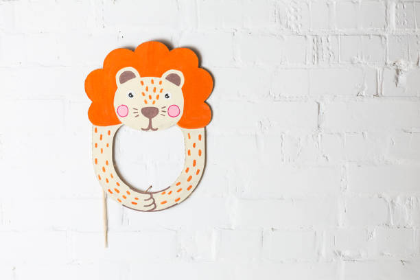 istock Bright cardboard mask on a white brick wall. 1832891769