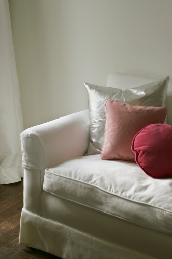 Detail of white sofa with three cushions