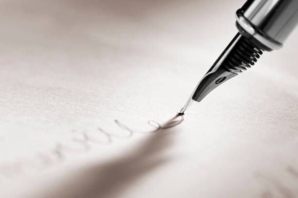 istock Fountain pen signing a signature on paperwork 183290076